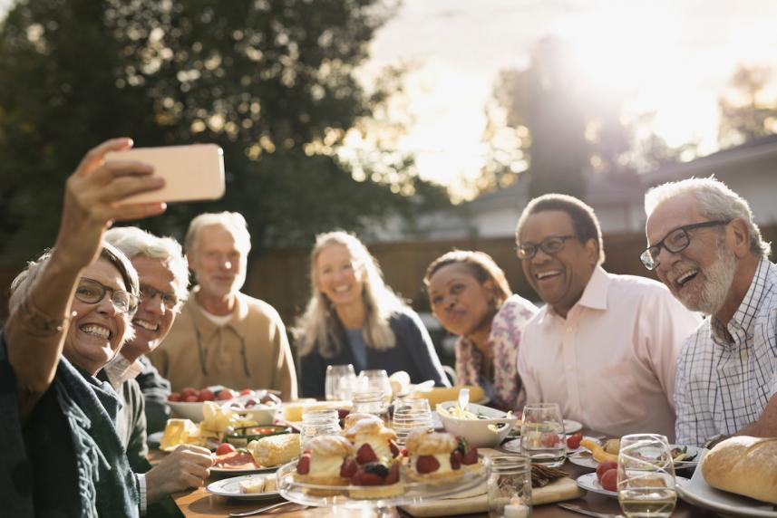 Group of men and women talking at an outdoor party