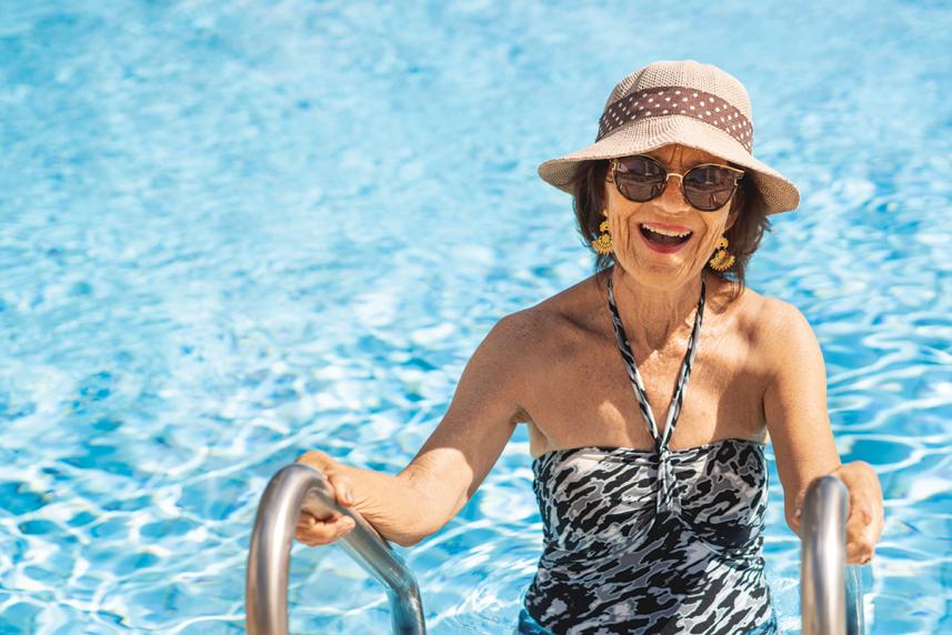 Woman climbing out of the pool on a ladder