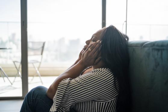 Woman holding her head, suppressing pain