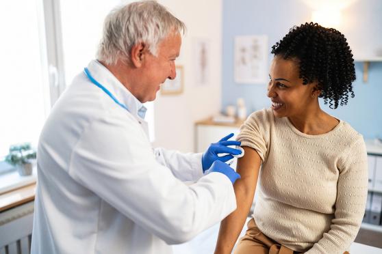 Women getting the flu shot from a doctor